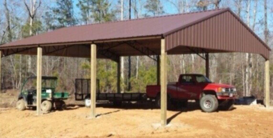 Open carport pole barn with red metal roof