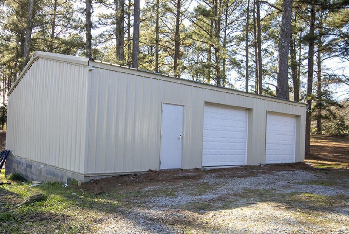 Tan metal building with garage doors
